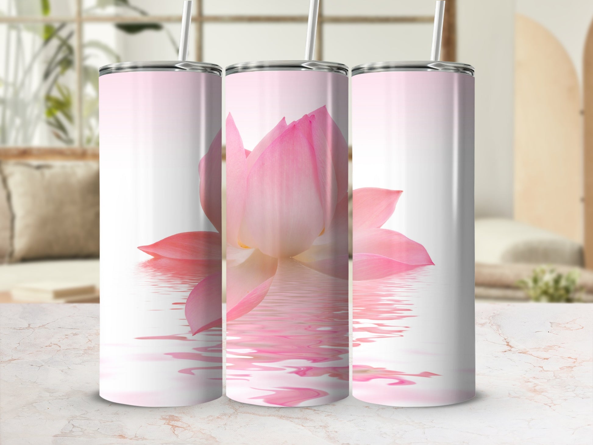 Three tumblers with a pink lotus flower reflecting on water.
