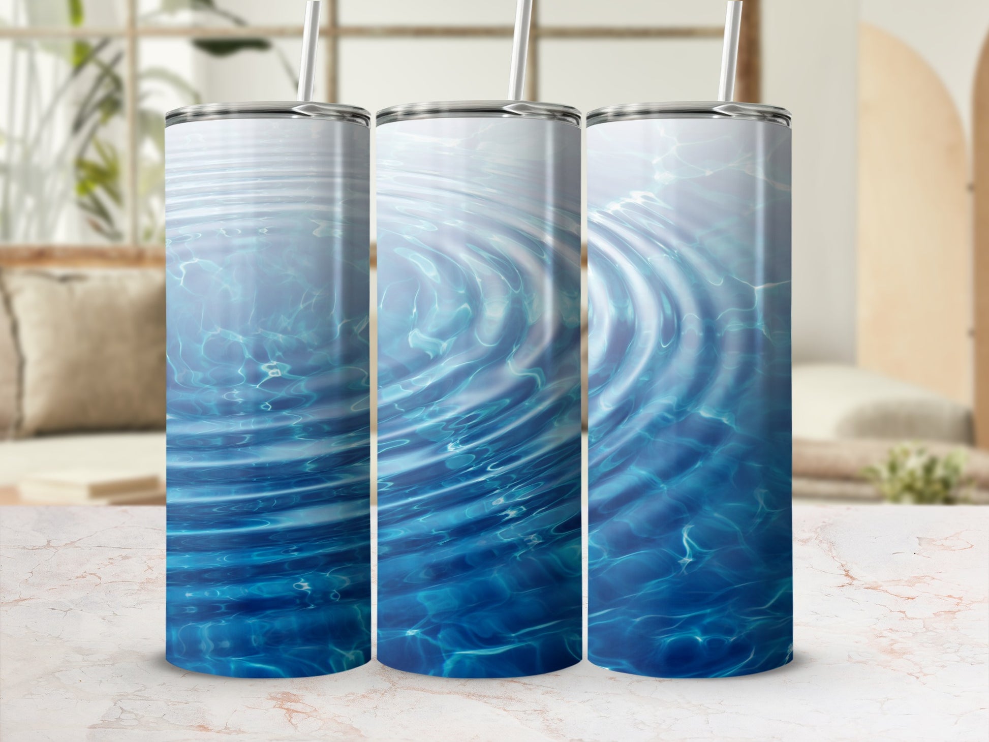 Three tumblers with a rippling water design on a marble surface.