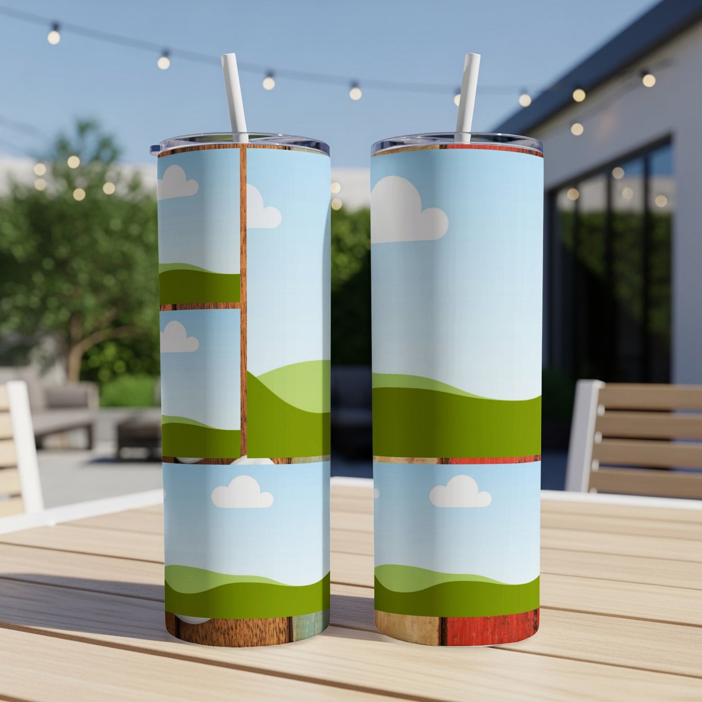 Two tumblers with a cartoon landscape design of green hills and clouds.