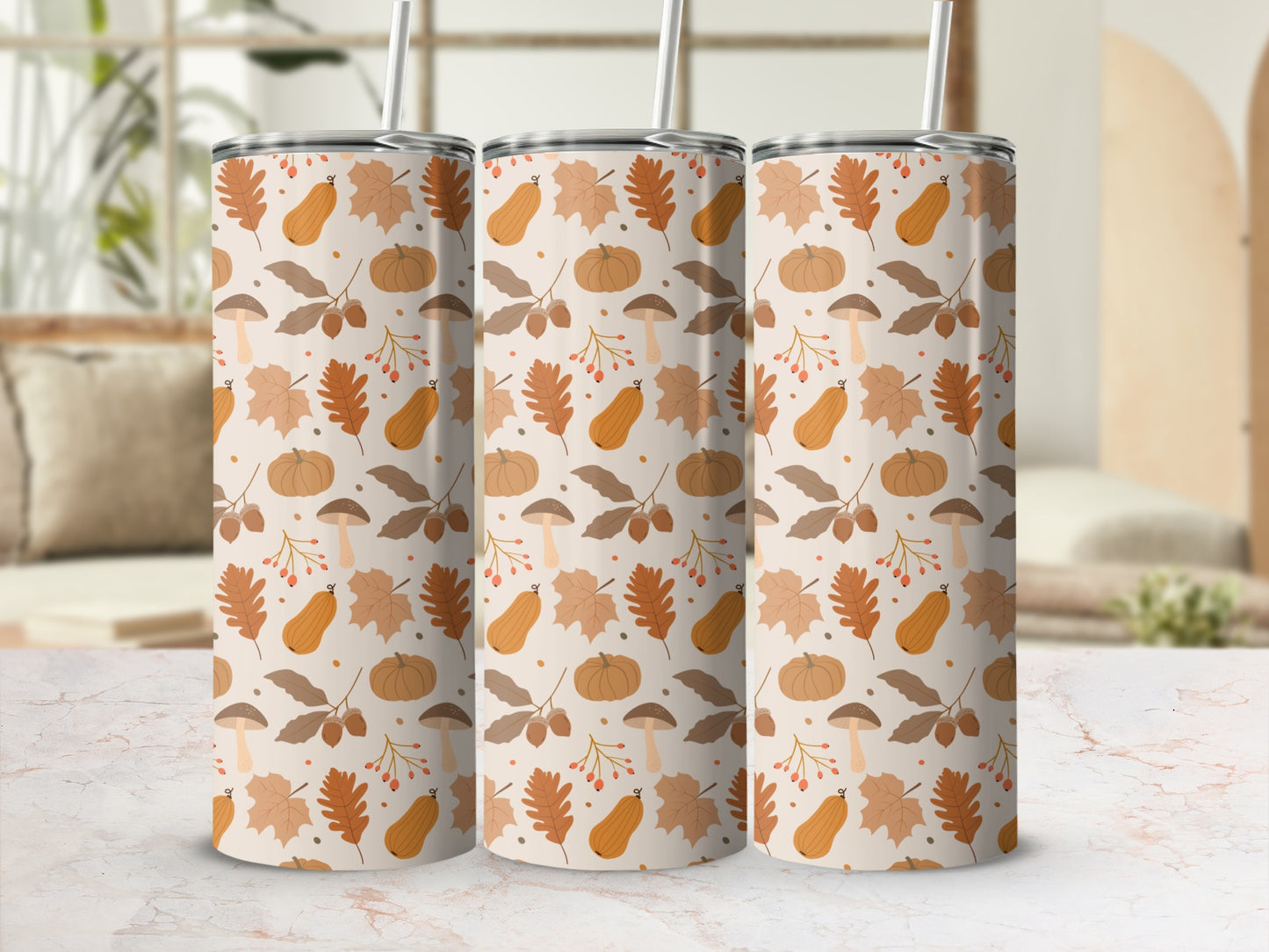 Three tumblers with a fall-themed pattern of pumpkins, leaves, and mushrooms.