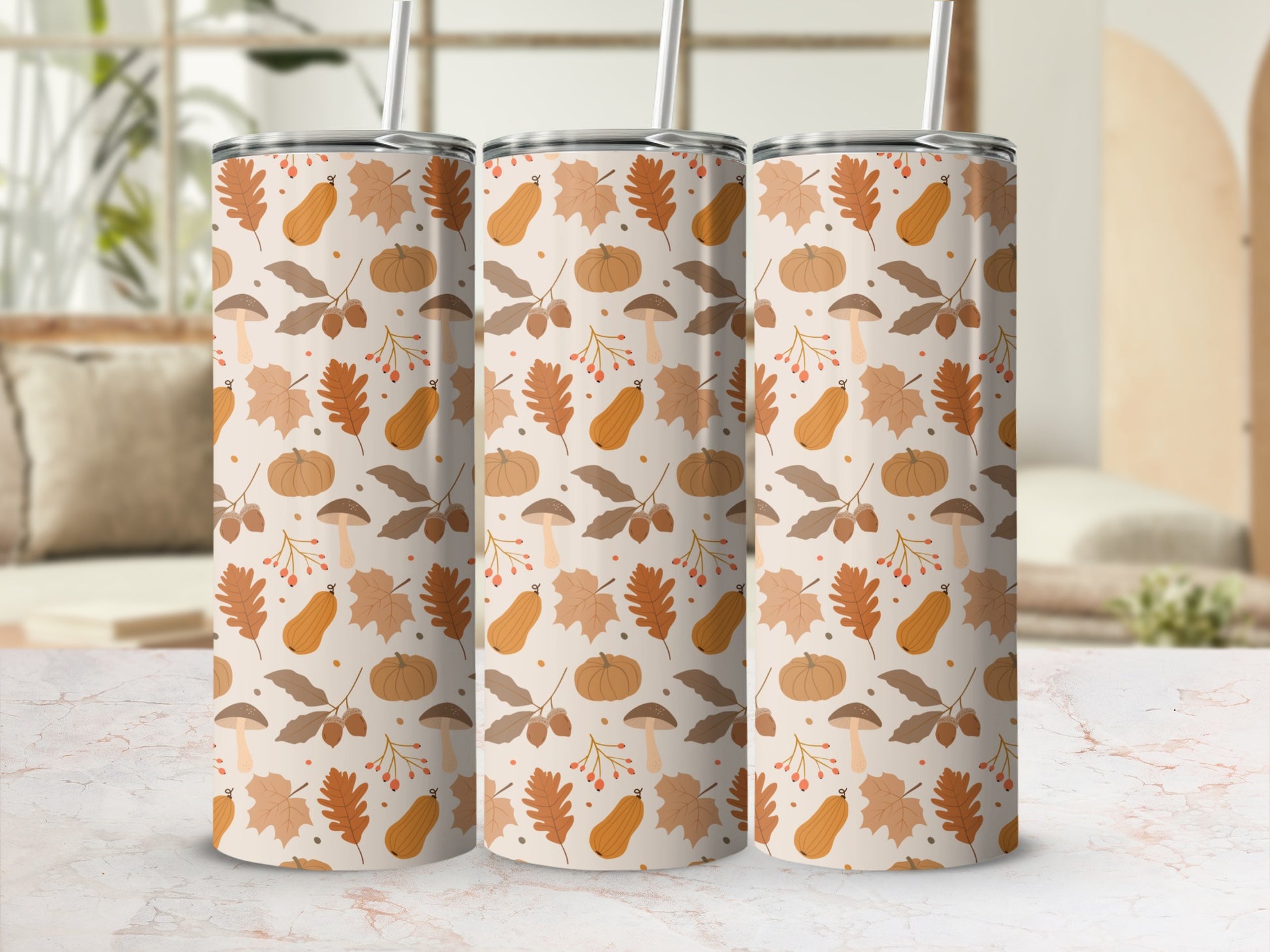 Three tumblers with a fall-themed pattern of pumpkins, leaves, and mushrooms.