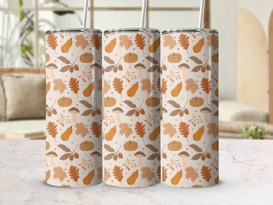 Three tumblers with a fall-themed pattern of pumpkins, leaves, and mushrooms.