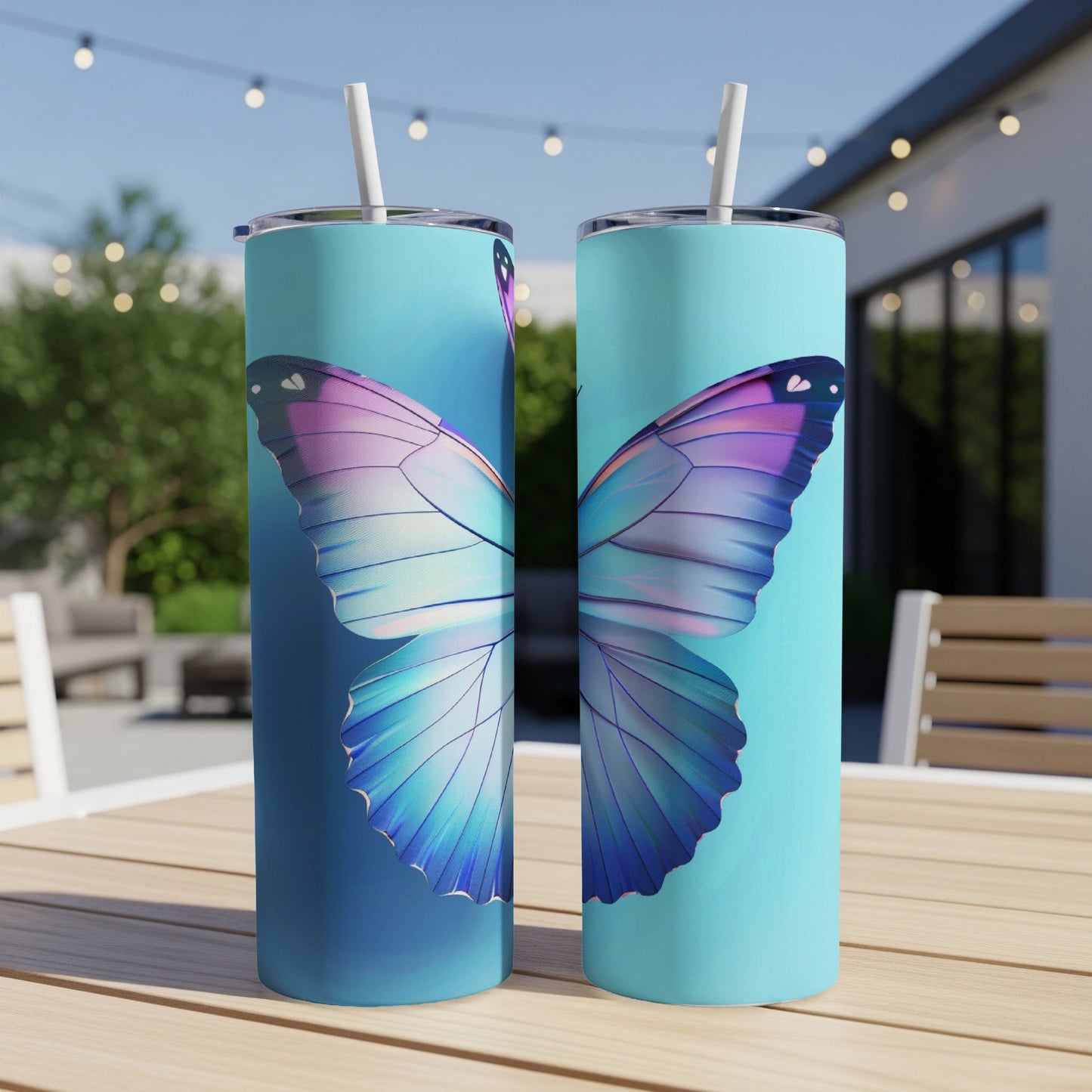 Two skinny tumblers with large purple and blue butterfly wings on a teal background.