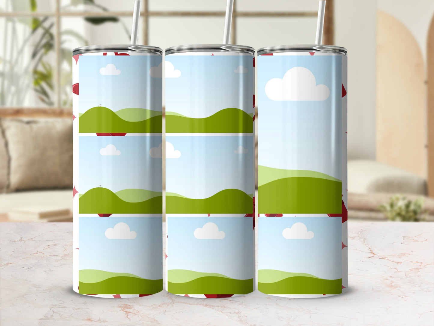Three tumblers with a red heart and green landscape design.