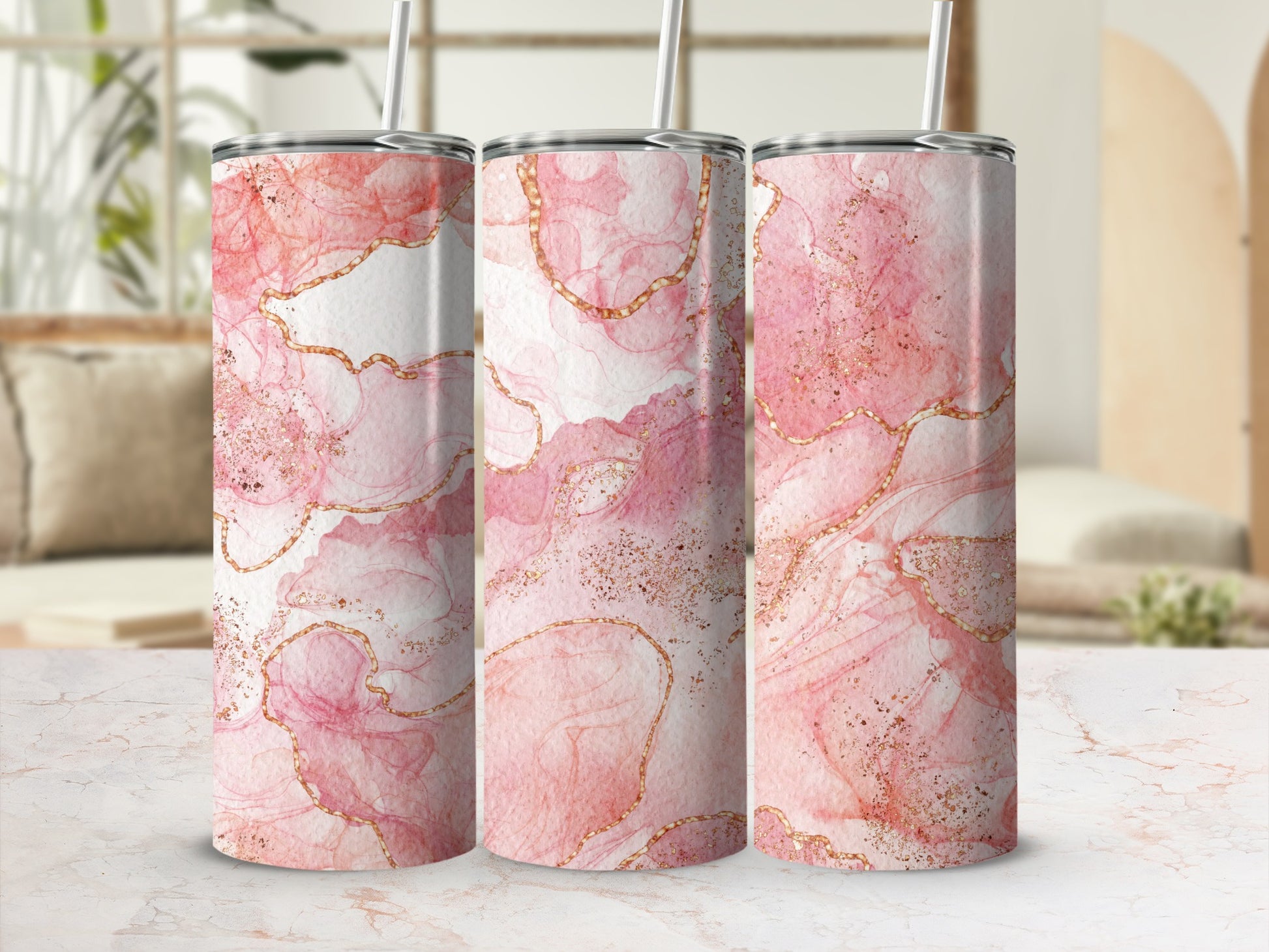 Three tumblers with abstract pink and gold marbling design.