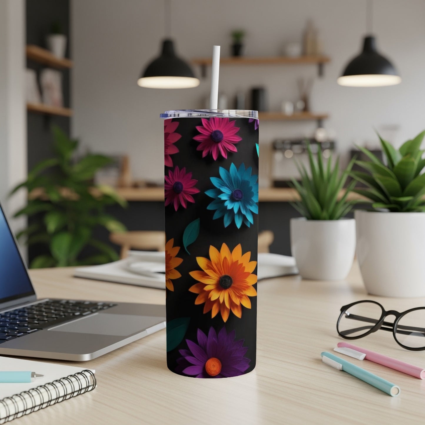 Black tumbler with colorful floral pattern and straw.
