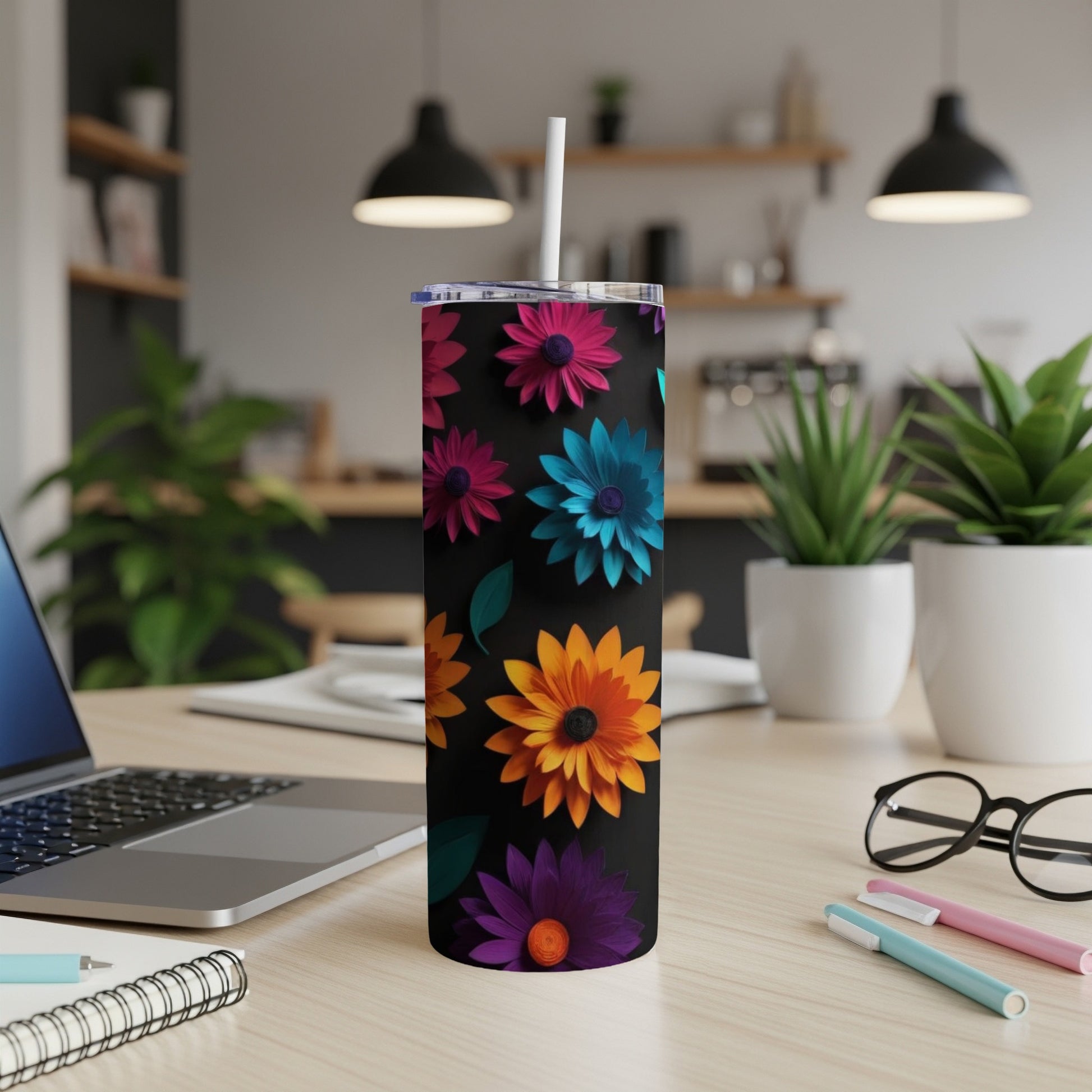 Black tumbler with colorful floral pattern and straw.