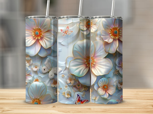 Floral butterflies adorn three tall tumblers on a wooden surface.