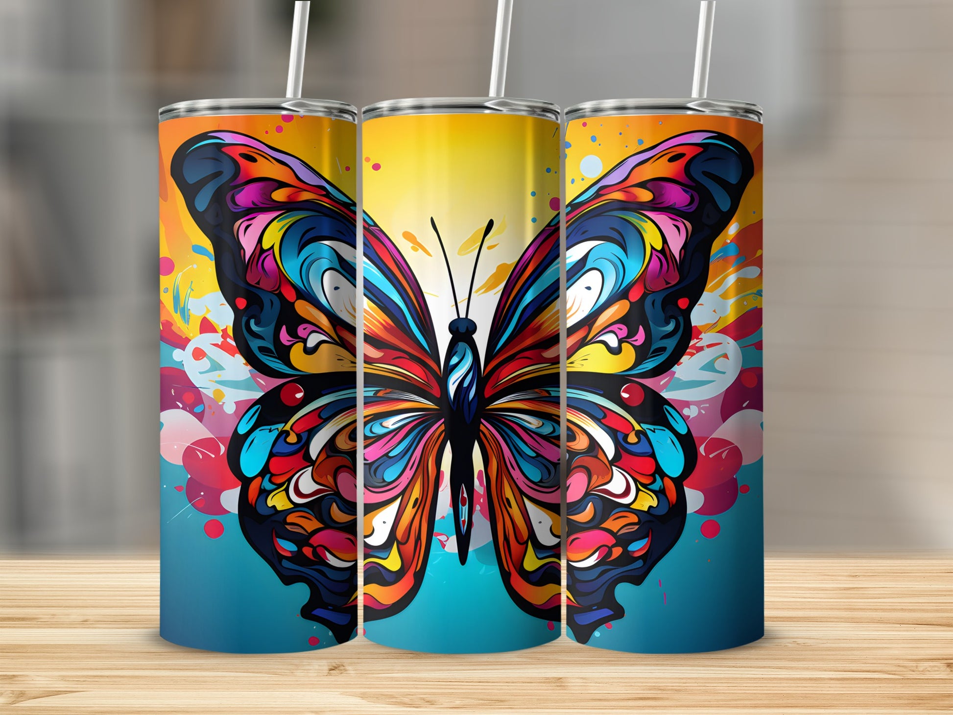 Colorful butterfly pattern on three tumblers with straws.