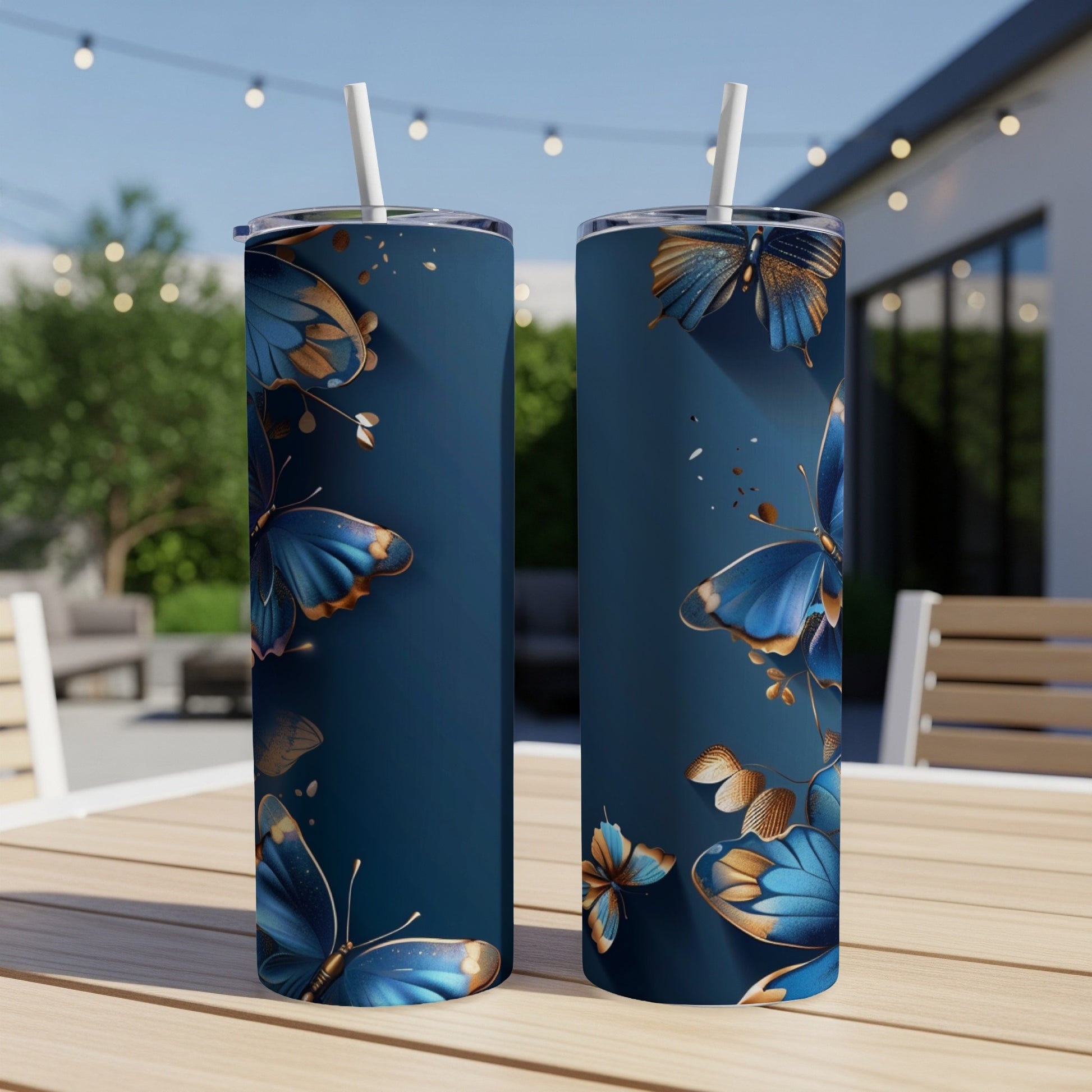 Two navy tumblers with gold and blue butterfly design.