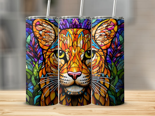 Stained glass lion tumbler with colorful floral background.