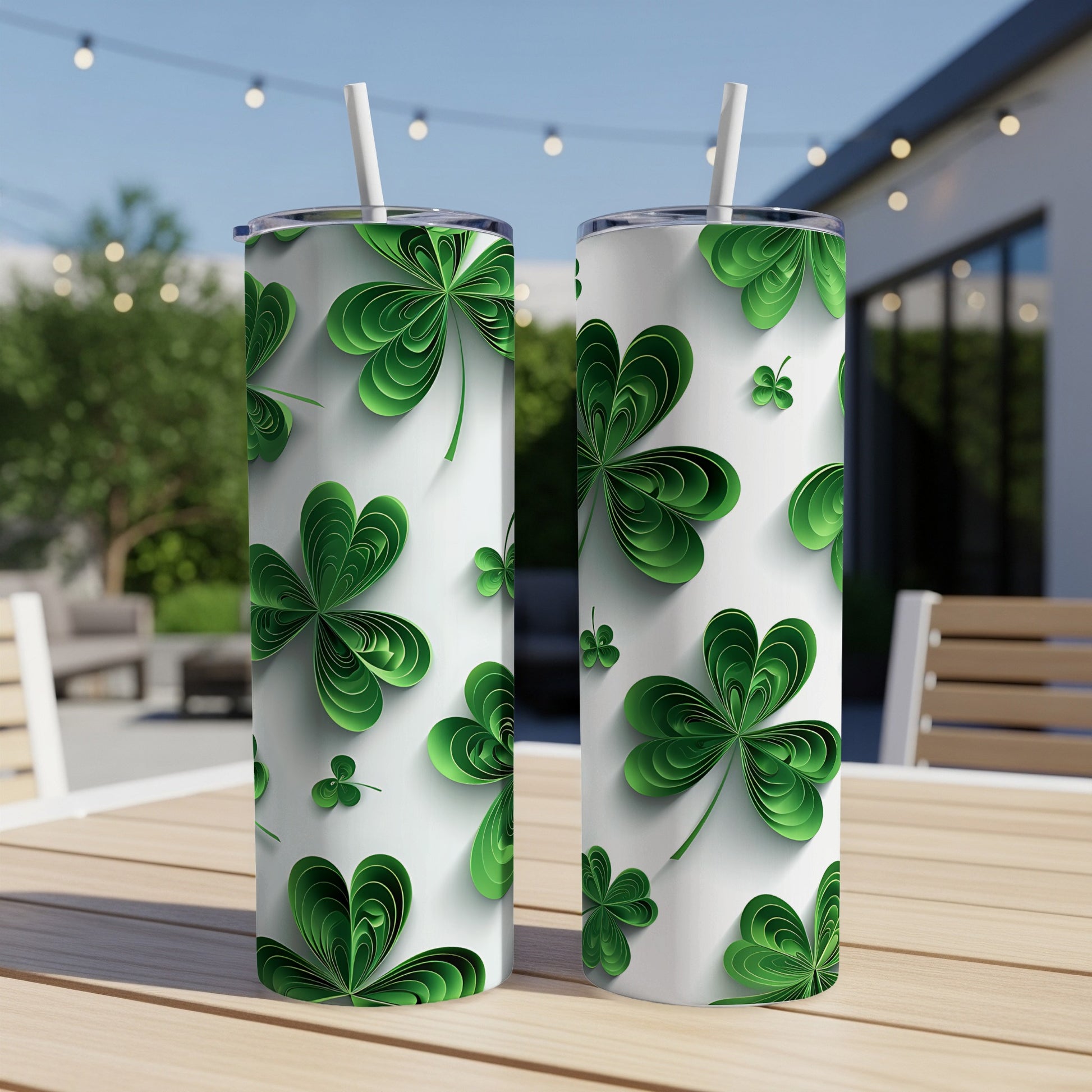 Two white tumblers with a repeating shamrock pattern sit on a wooden table.