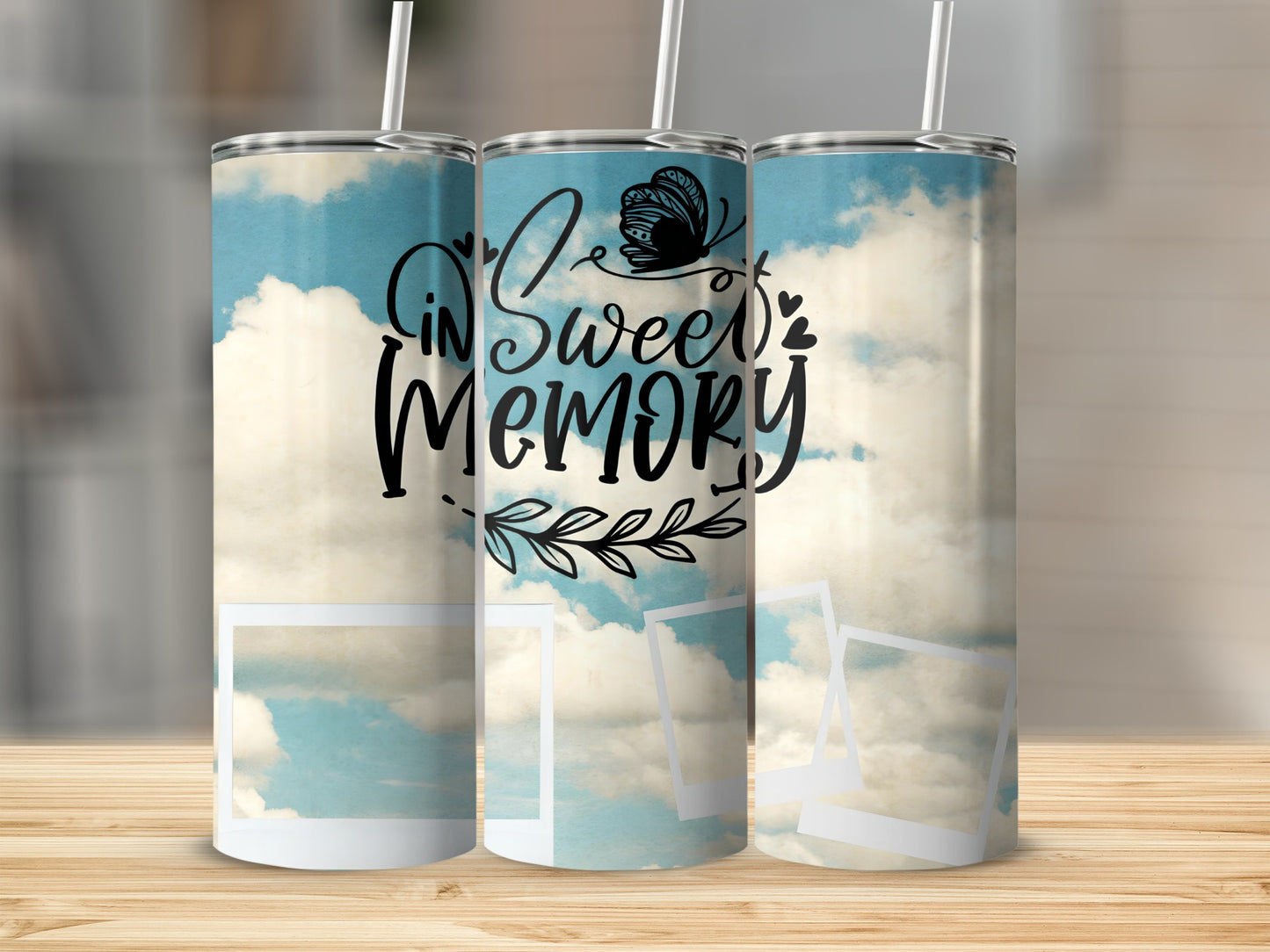 Three tumblers with a sky and cloud design featuring the text "In Sweet Memory."