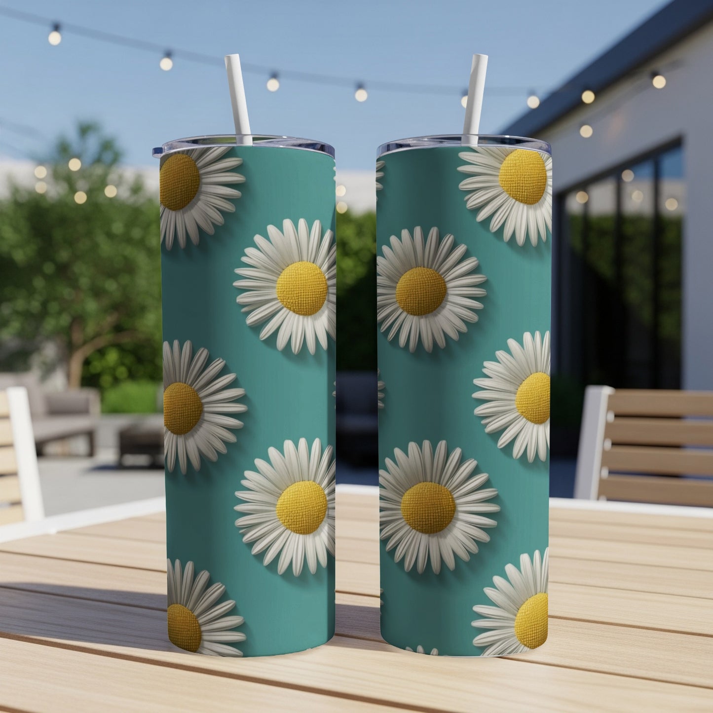 Two tumblers with a repeating daisy pattern on a teal background.