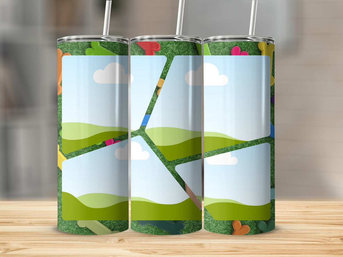 Three tumblers with a playful cartoon scene of grass, clouds, and colorful shapes.