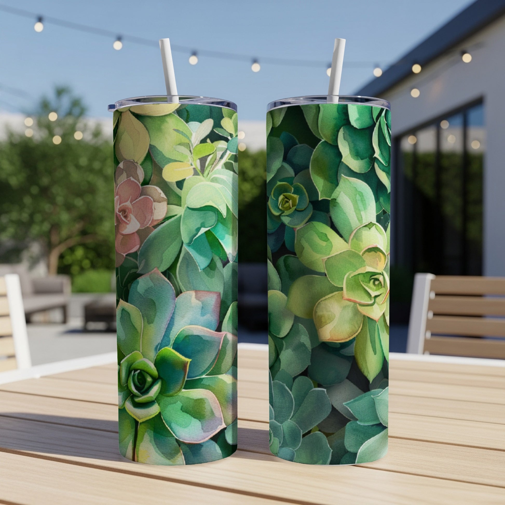 Two tumblers with watercolor succulent design on a wooden table.