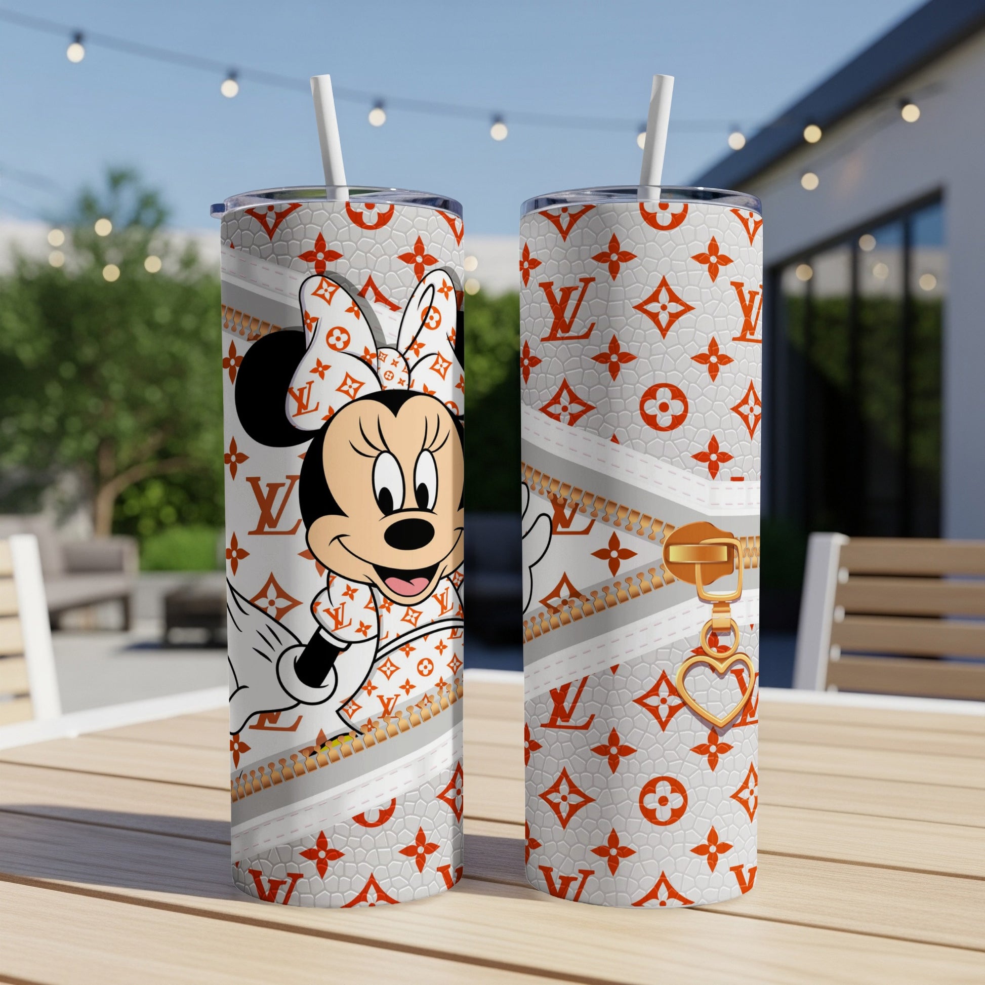 Minnie Mouse in designer outfit on white tumbler with gold zipper and heart charm.