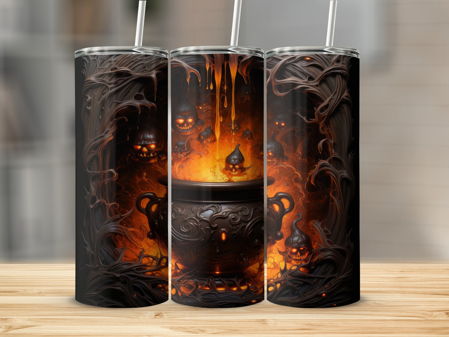 Three tumblers featuring a dark, spooky cauldron with glowing skulls and flames.