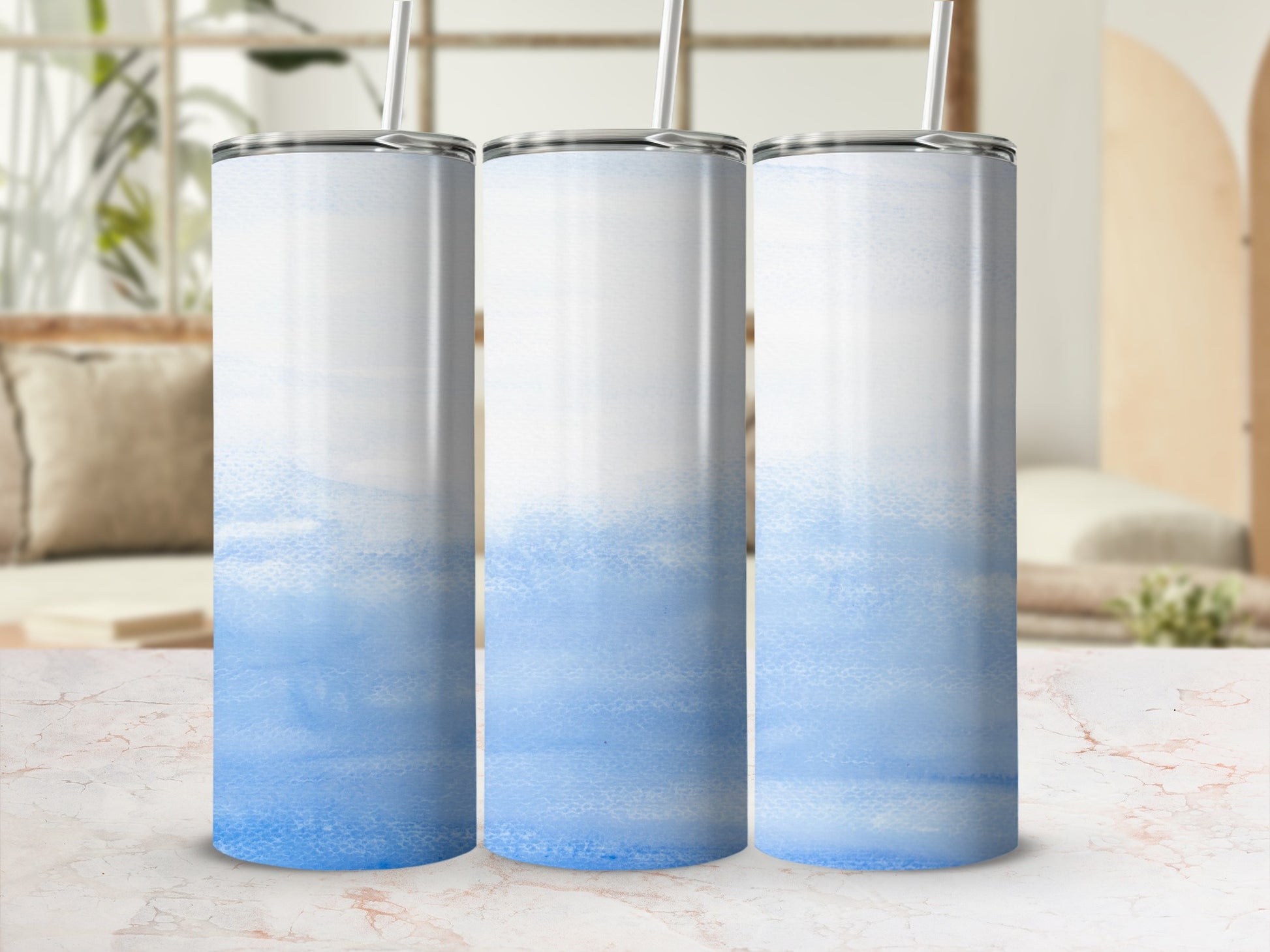 Three tall, skinny tumblers with a watercolor blue design.