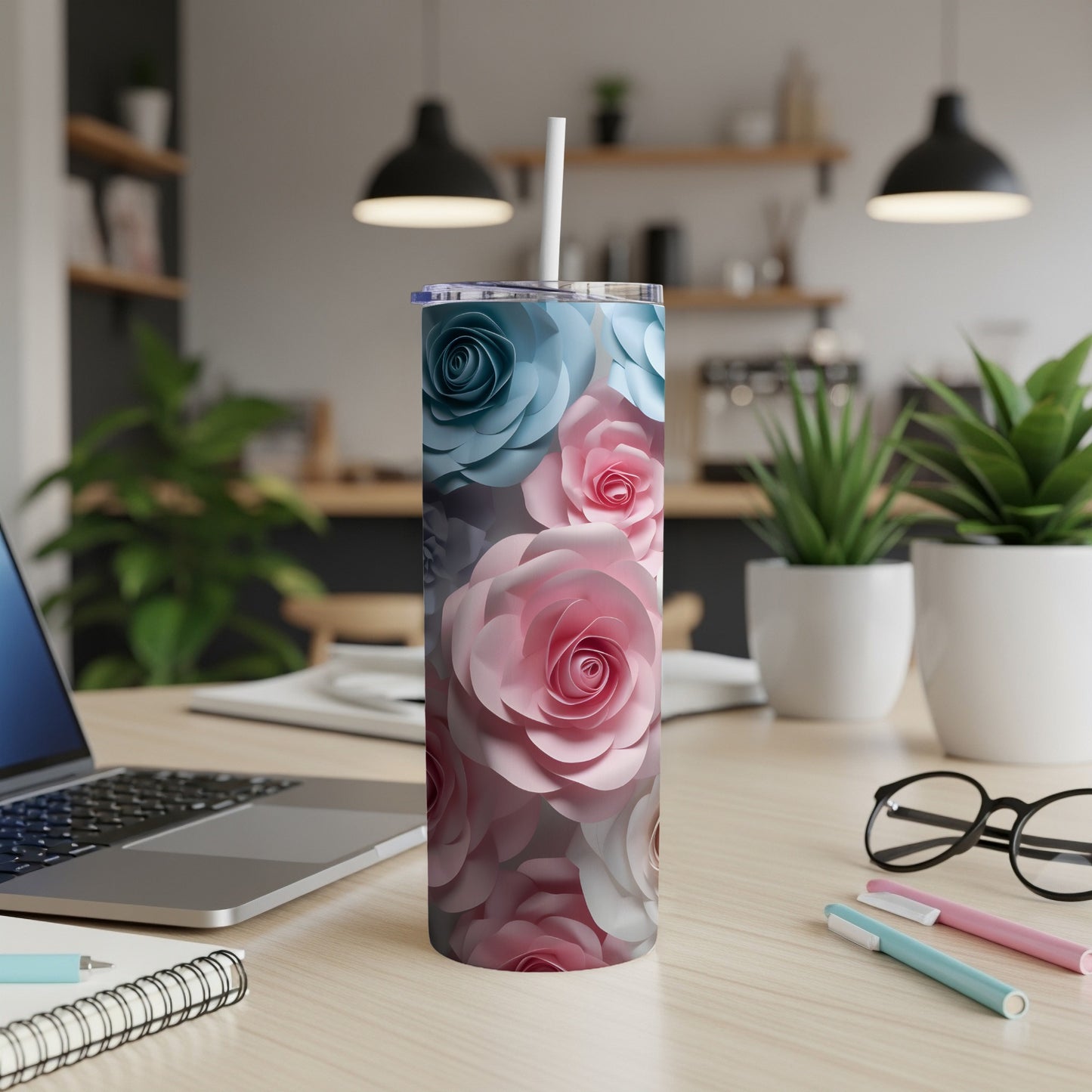 Tumbler with a floral pattern of pink and blue roses.