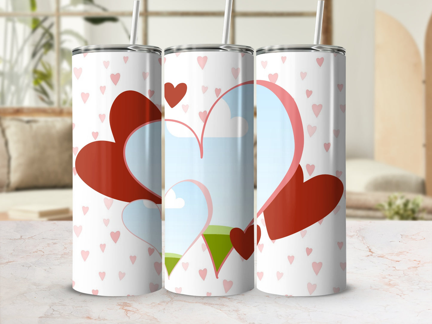 Three tall tumblers with a white background patterned with small pink hearts and large red hearts.