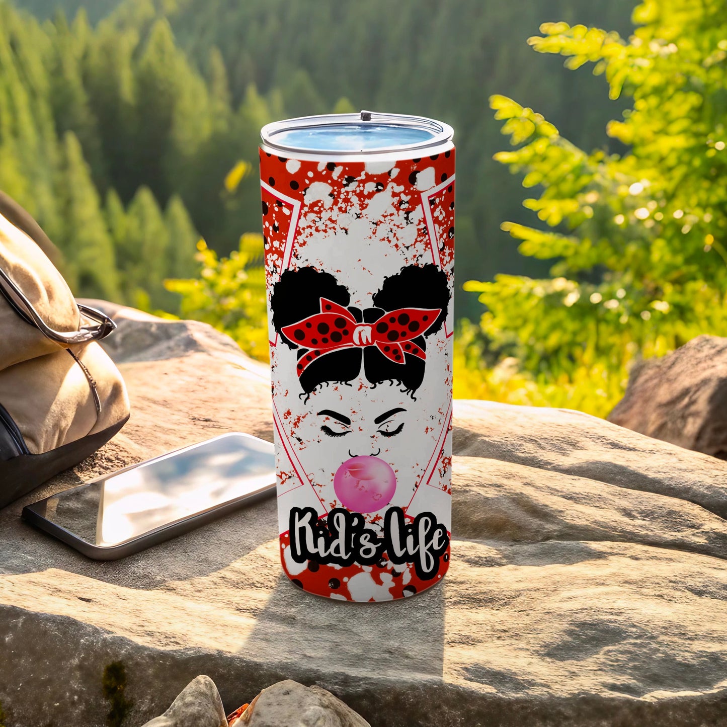 Red and white tumbler with "Kid's Life" bubble, outdoors setting.