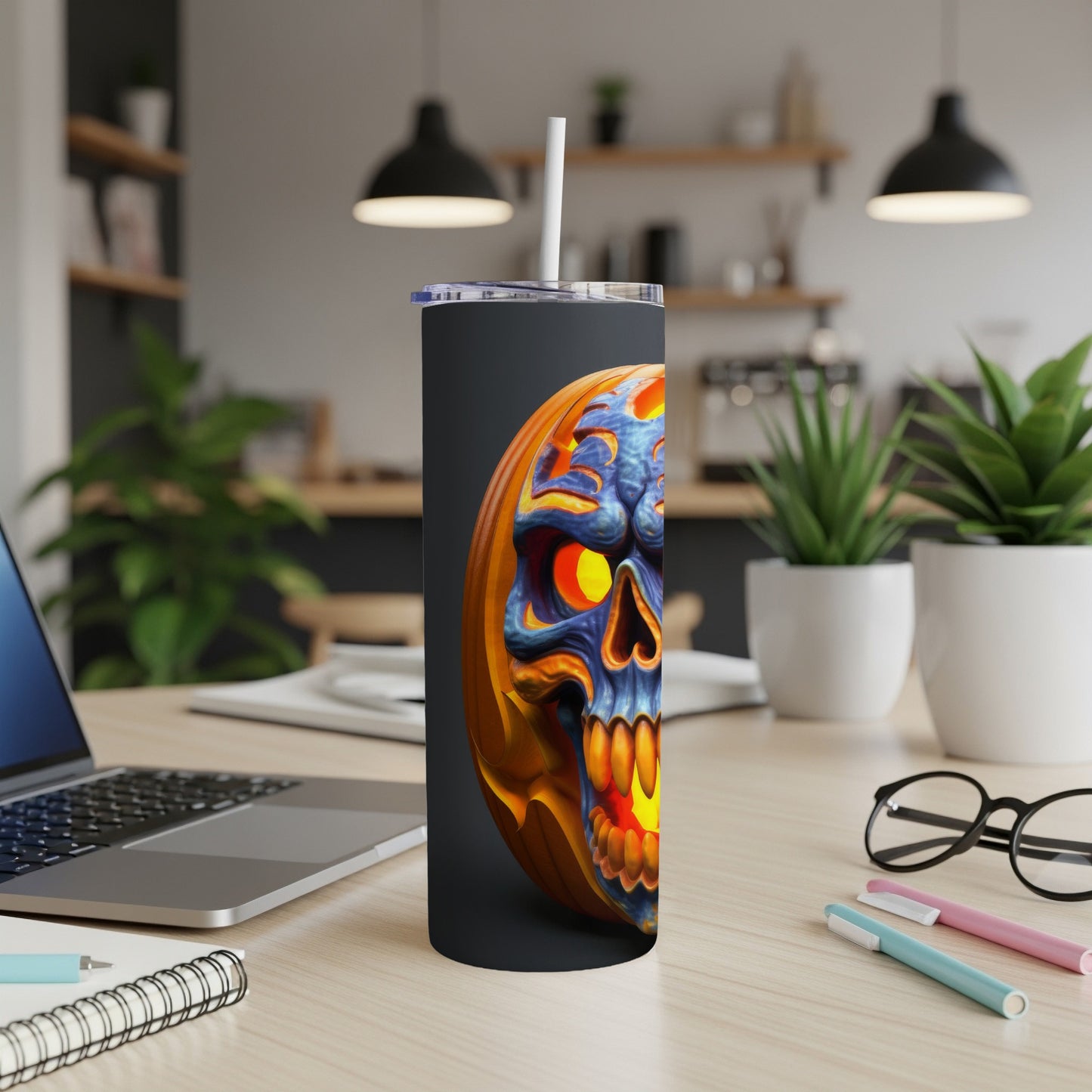 Tumbler with carved jack-o'-lantern skull design, featuring glowing eyes and teeth.