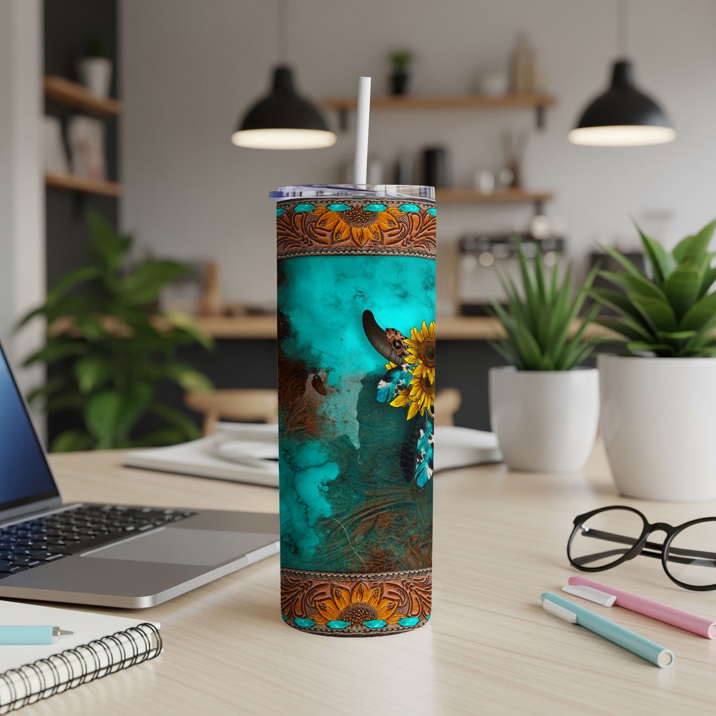 Turquoise tumbler with a bull skull, sunflowers, and Western-inspired pattern.