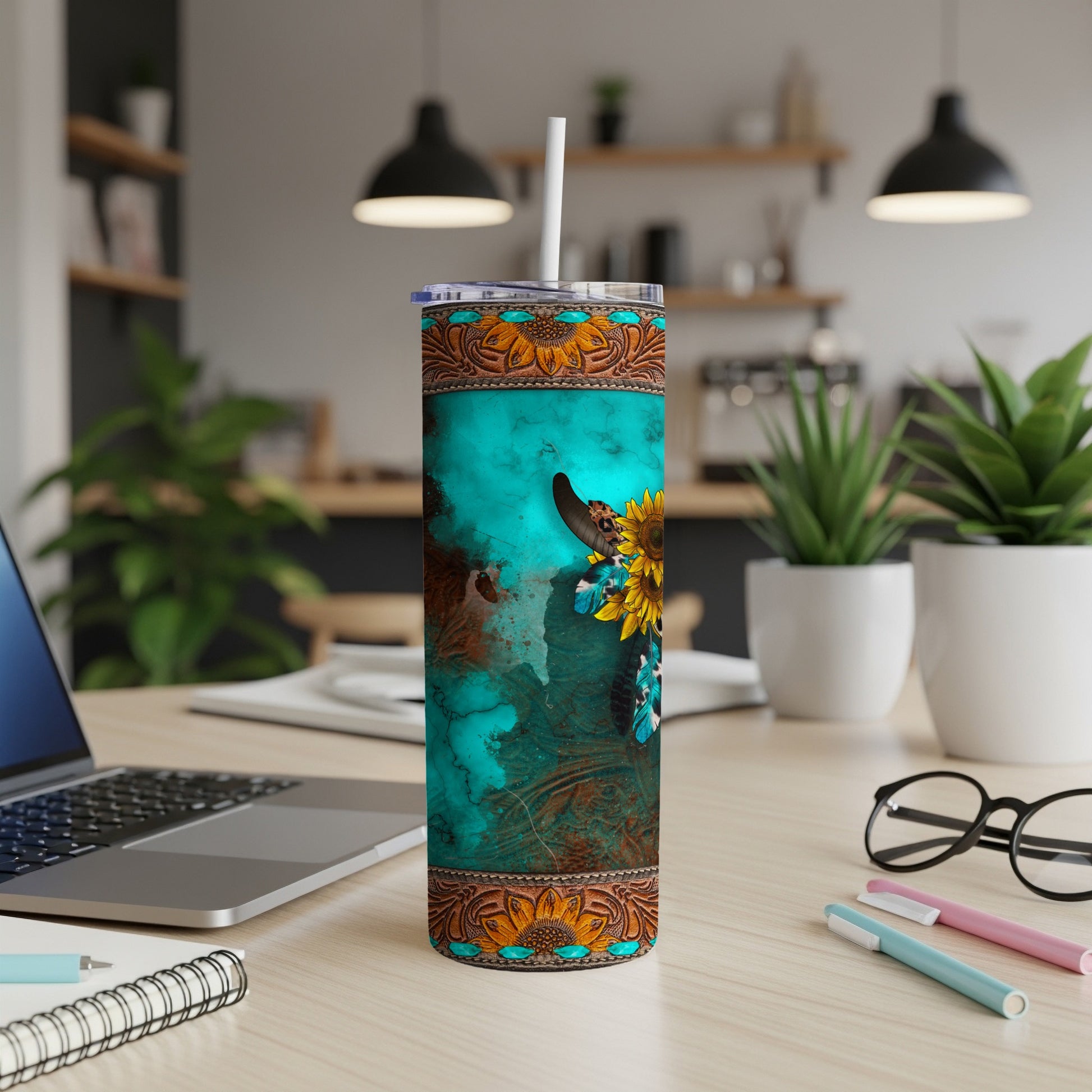 Turquoise tumbler with a bull skull, sunflowers, and Western-inspired pattern.