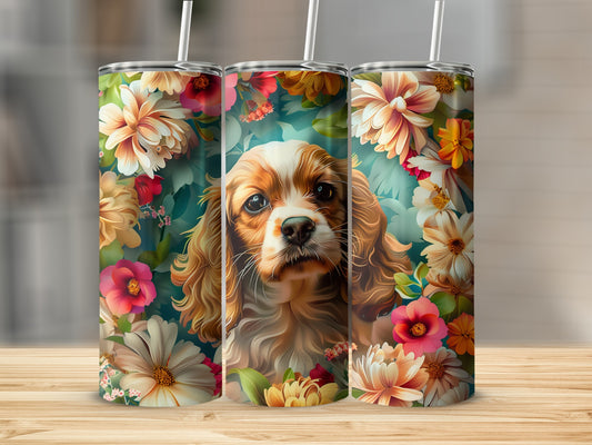 Cavalier King Charles Spaniel surrounded by colorful flowers on a tumbler.