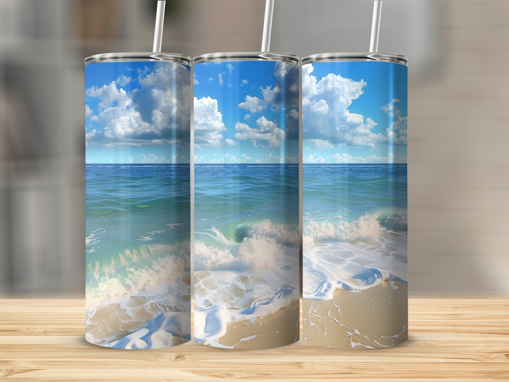 Three tumblers displaying a beach scene with ocean waves.