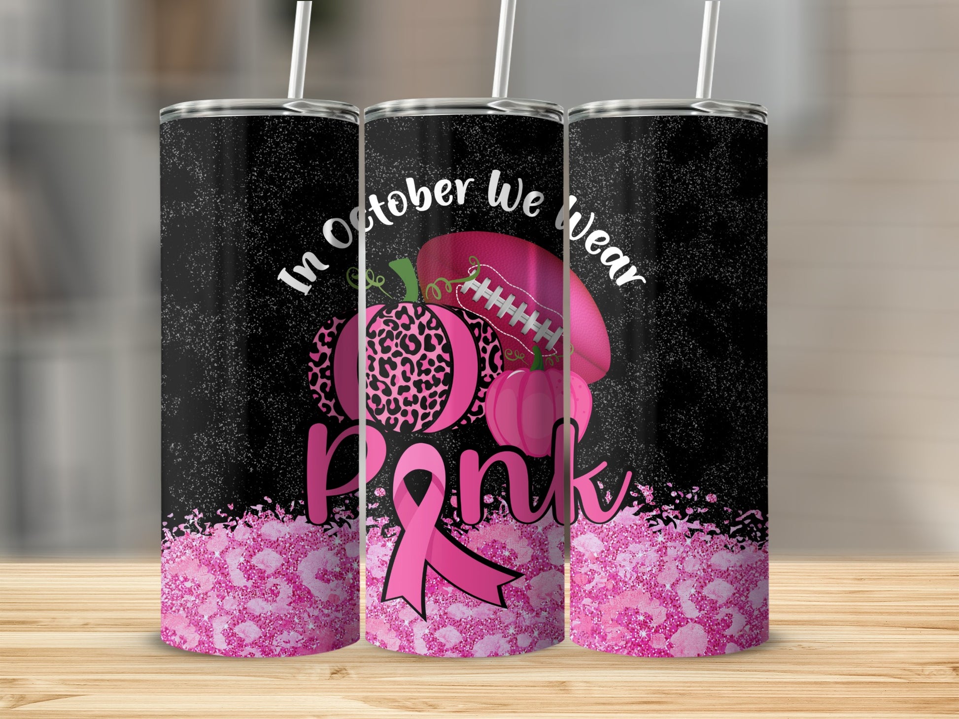 Three tumblers with "In October We Wear Pink" text, pumpkins, and pink ribbon.
