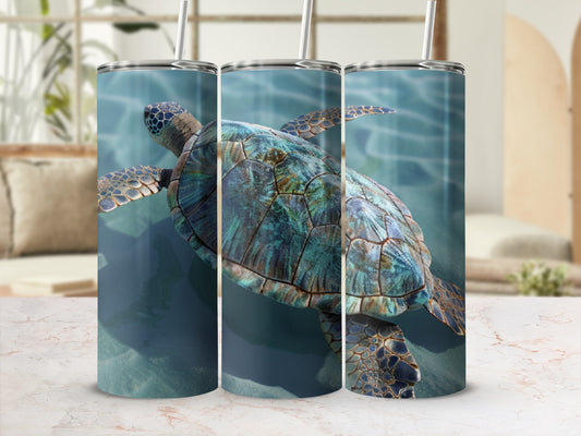 Tumbler with a sea turtle swimming in clear blue water.