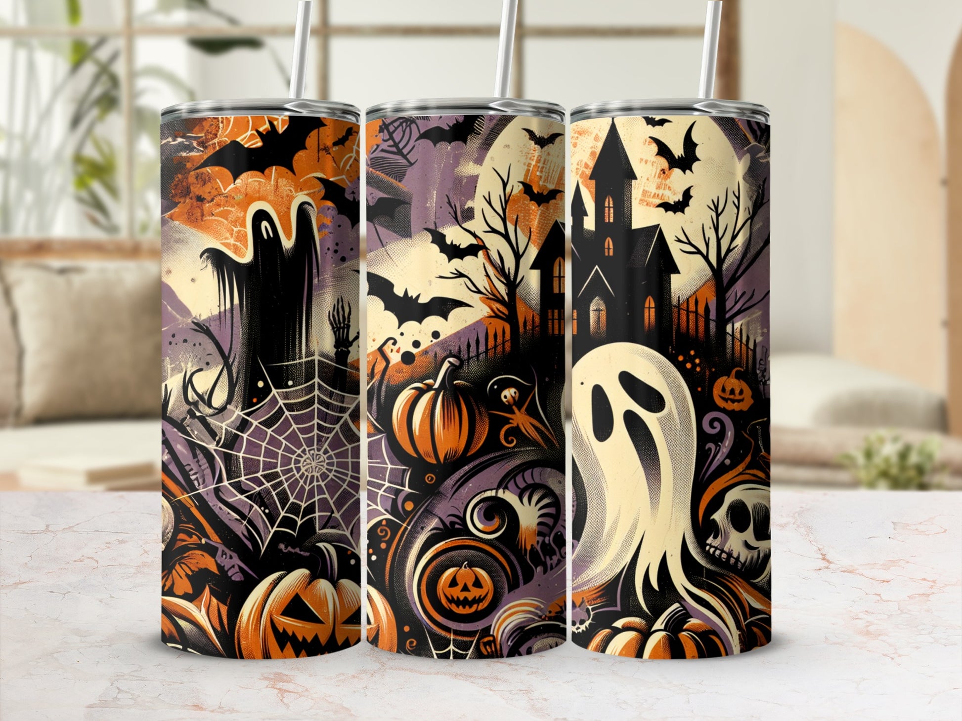 Three tumblers with Halloween designs featuring ghosts, bats, pumpkins, and a haunted house.