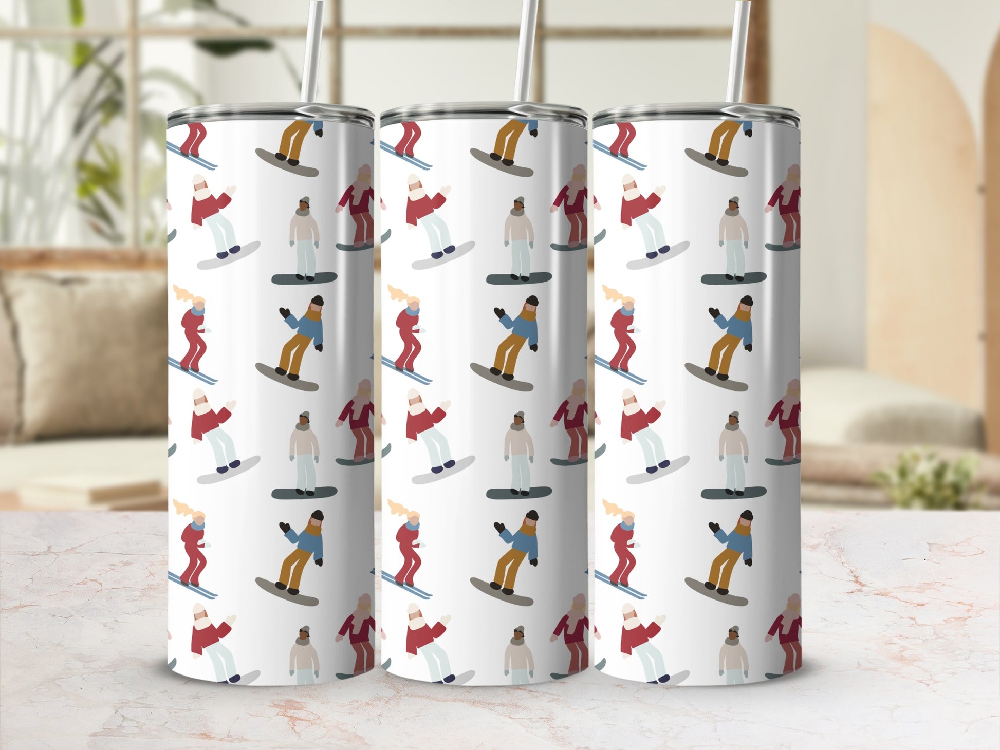 Three tumblers with a repeating pattern of skiers and snowboarders.