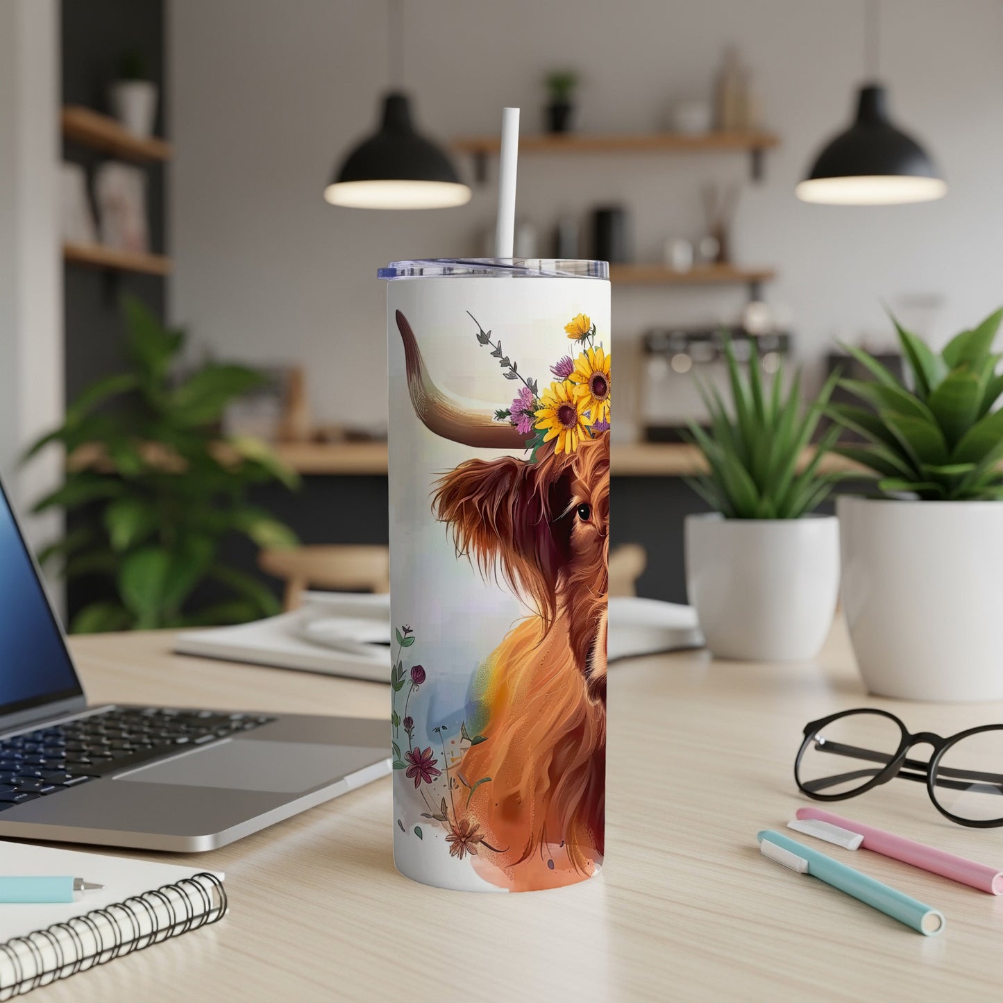 Highland cow with sunflowers on a tumbler with a straw.