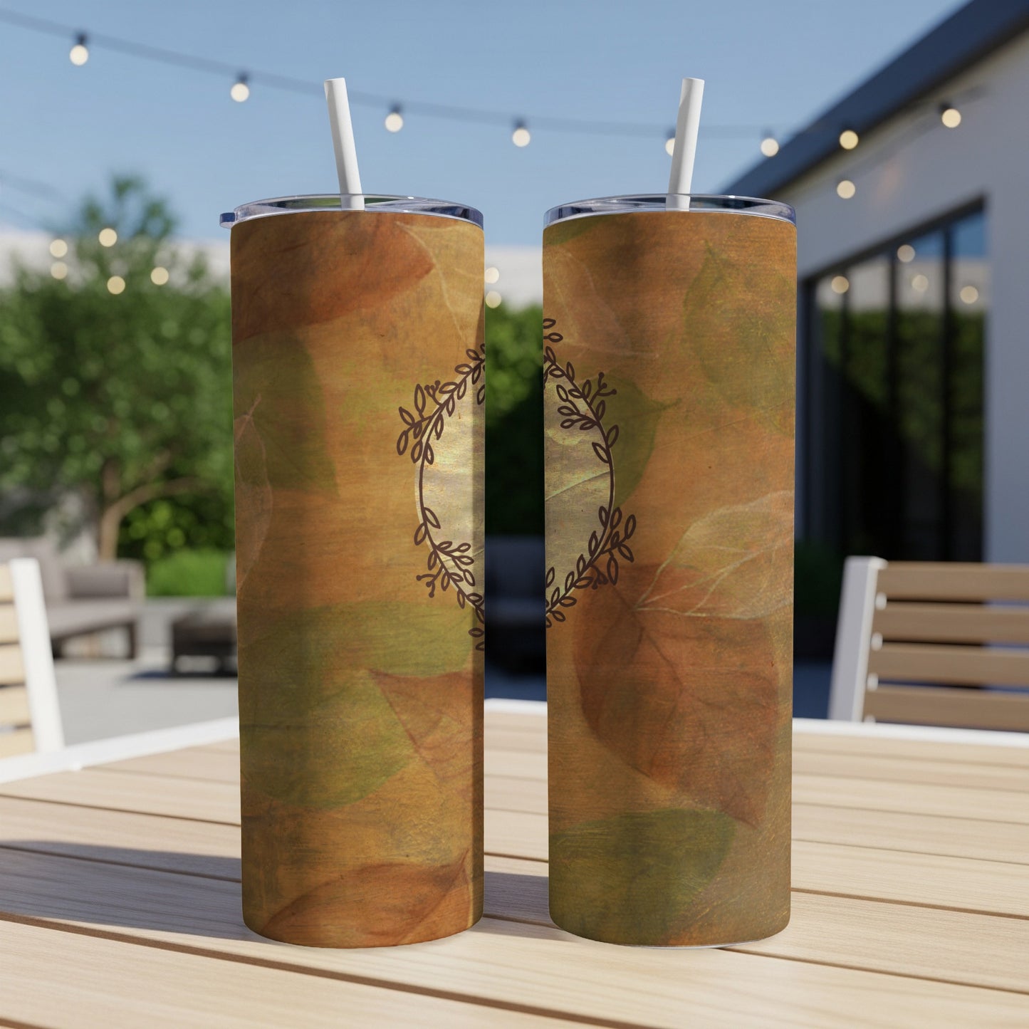 Two tall, slender tumblers with a rustic leaf pattern and a delicate vine wreath design.