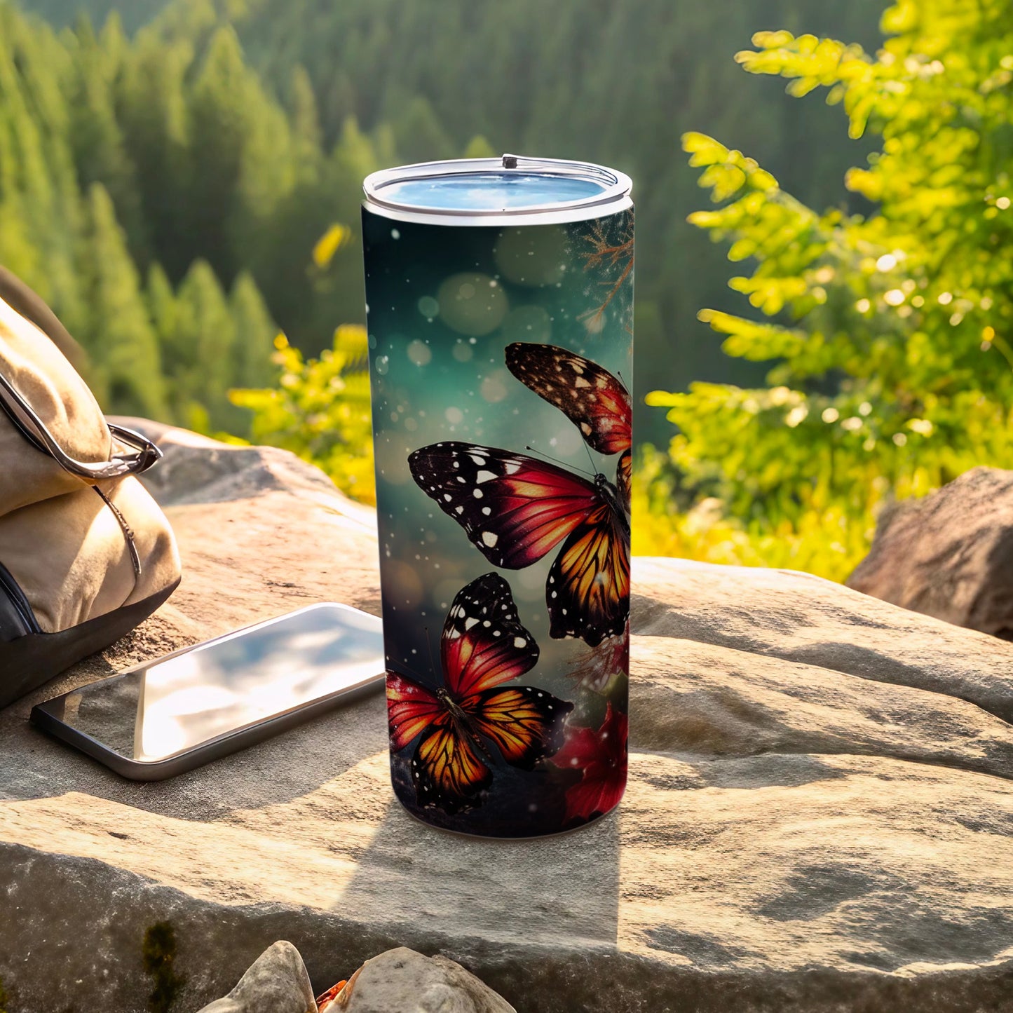 Tall tumbler with colorful butterflies against a bokeh forest background.