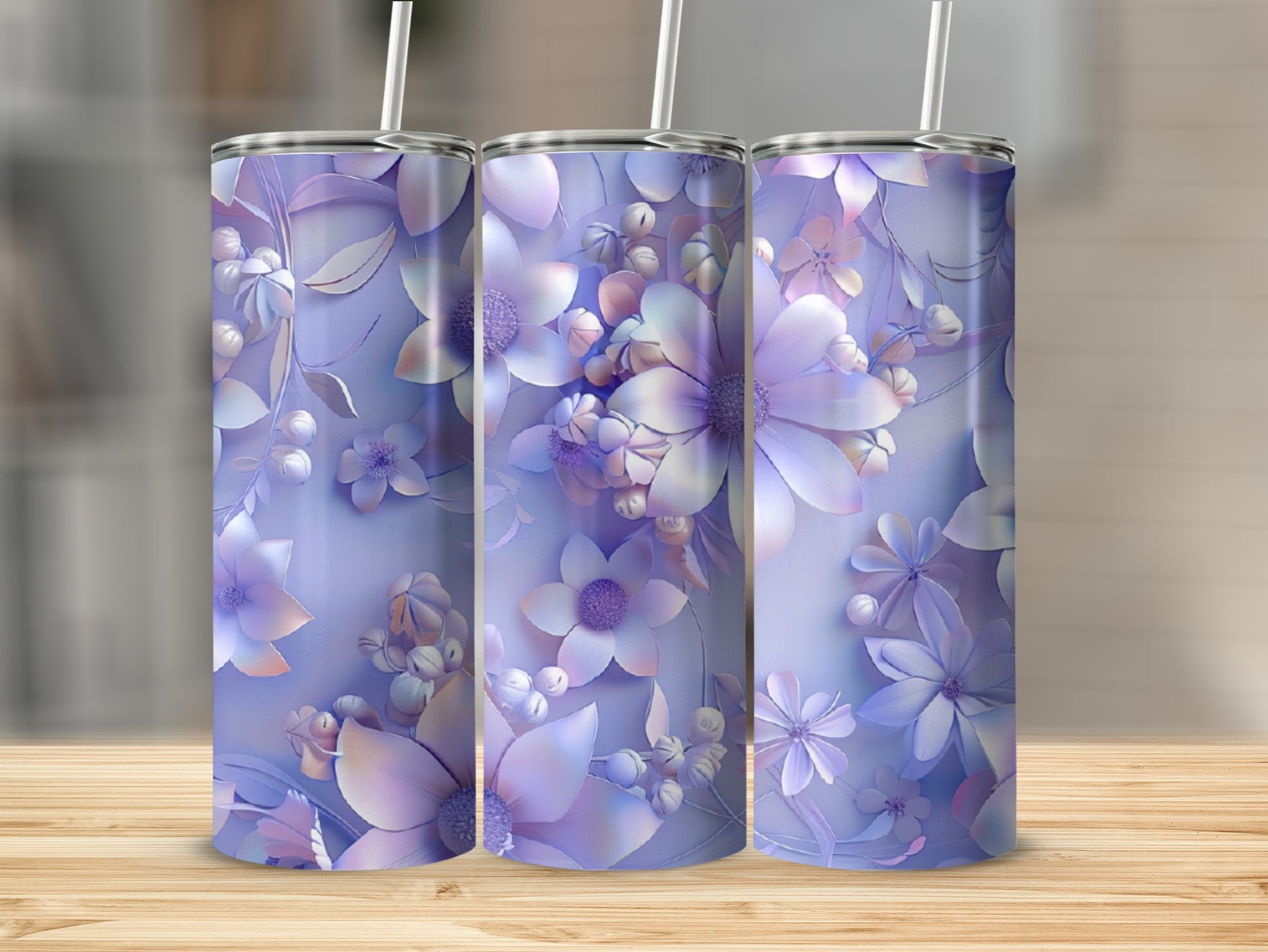 Three tumblers with a pastel floral design on a wooden surface.