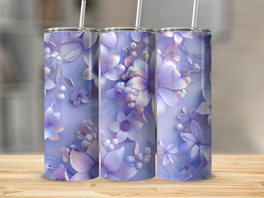 Three tumblers with a pastel floral design on a wooden surface.