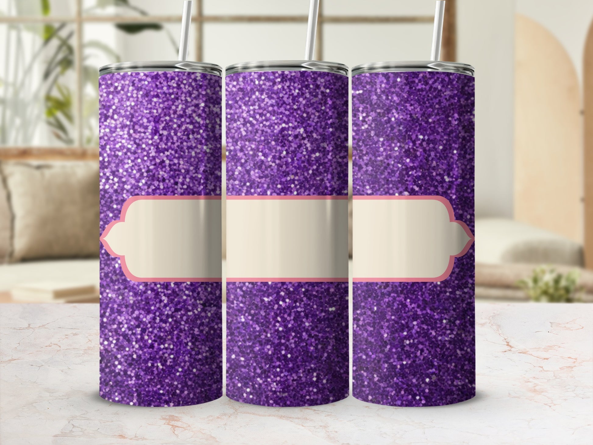 Three purple glitter tumblers with light-colored labels sit on a marbled surface.