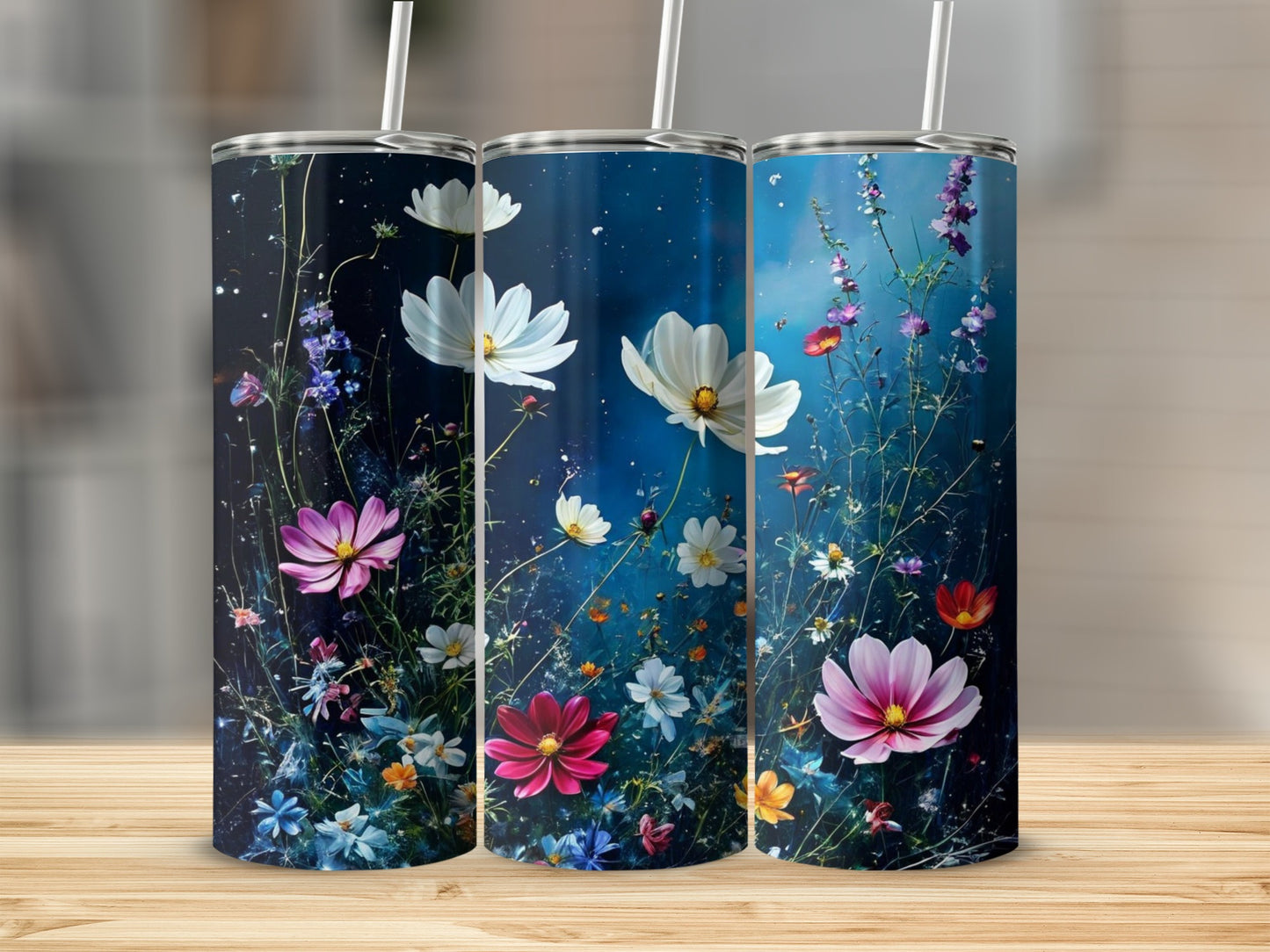 Three tumblers featuring colorful wildflowers against a dark blue, starry background.
