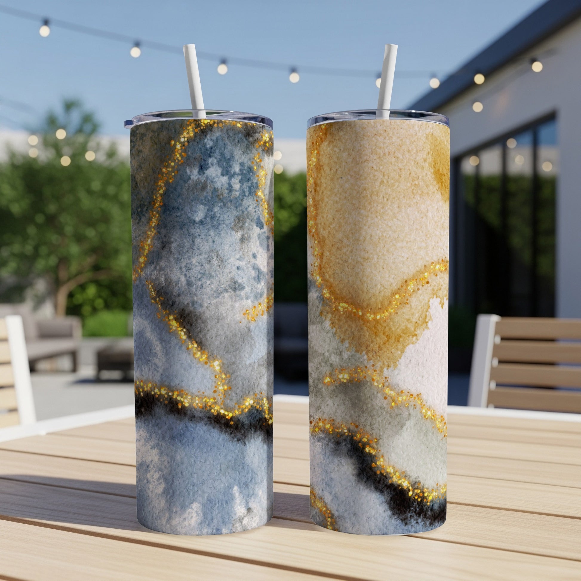 Two abstract marble-patterned tumblers with gold glitter accents.