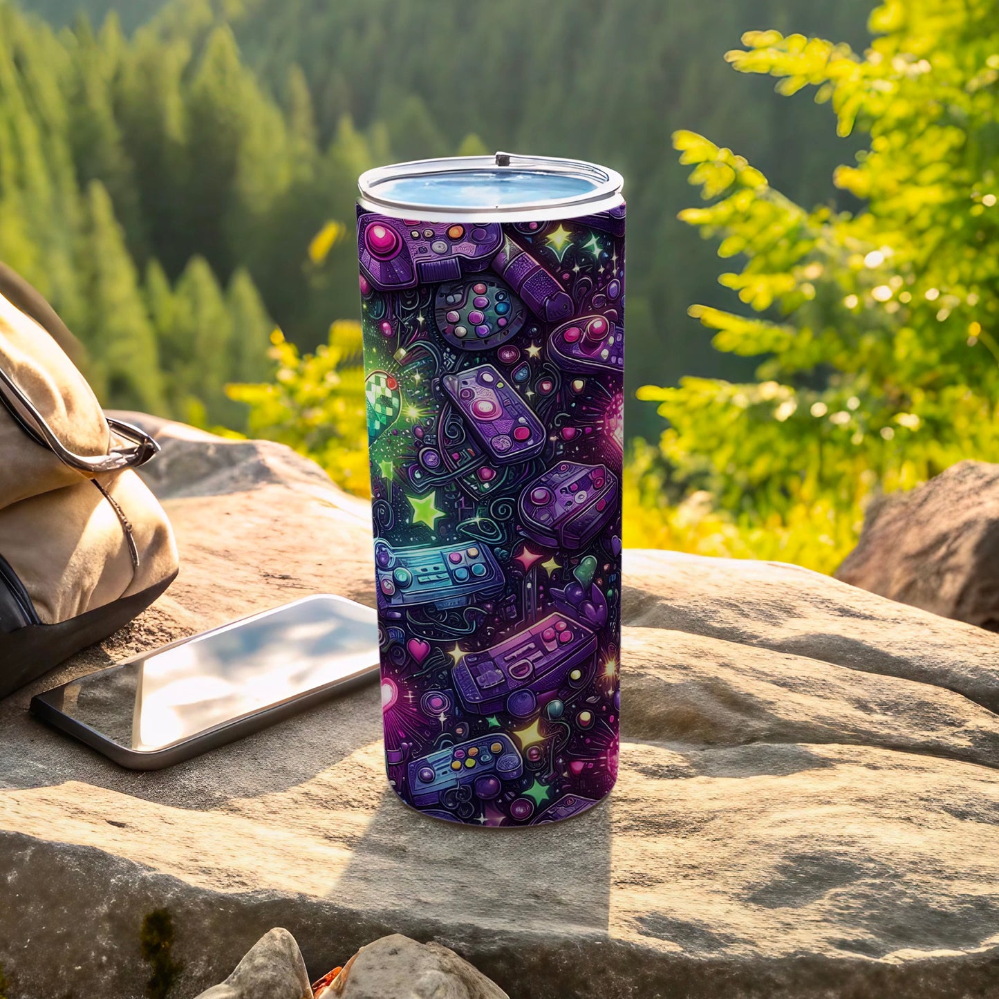 Purple tumbler with colorful video game controllers and icons on a rocky surface.