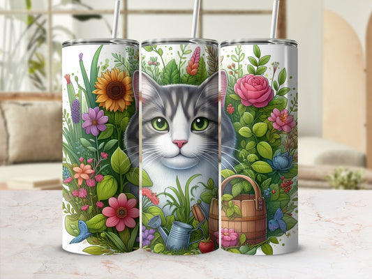 Gray and white tabby cat among colorful flowers and greenery on a tumbler.