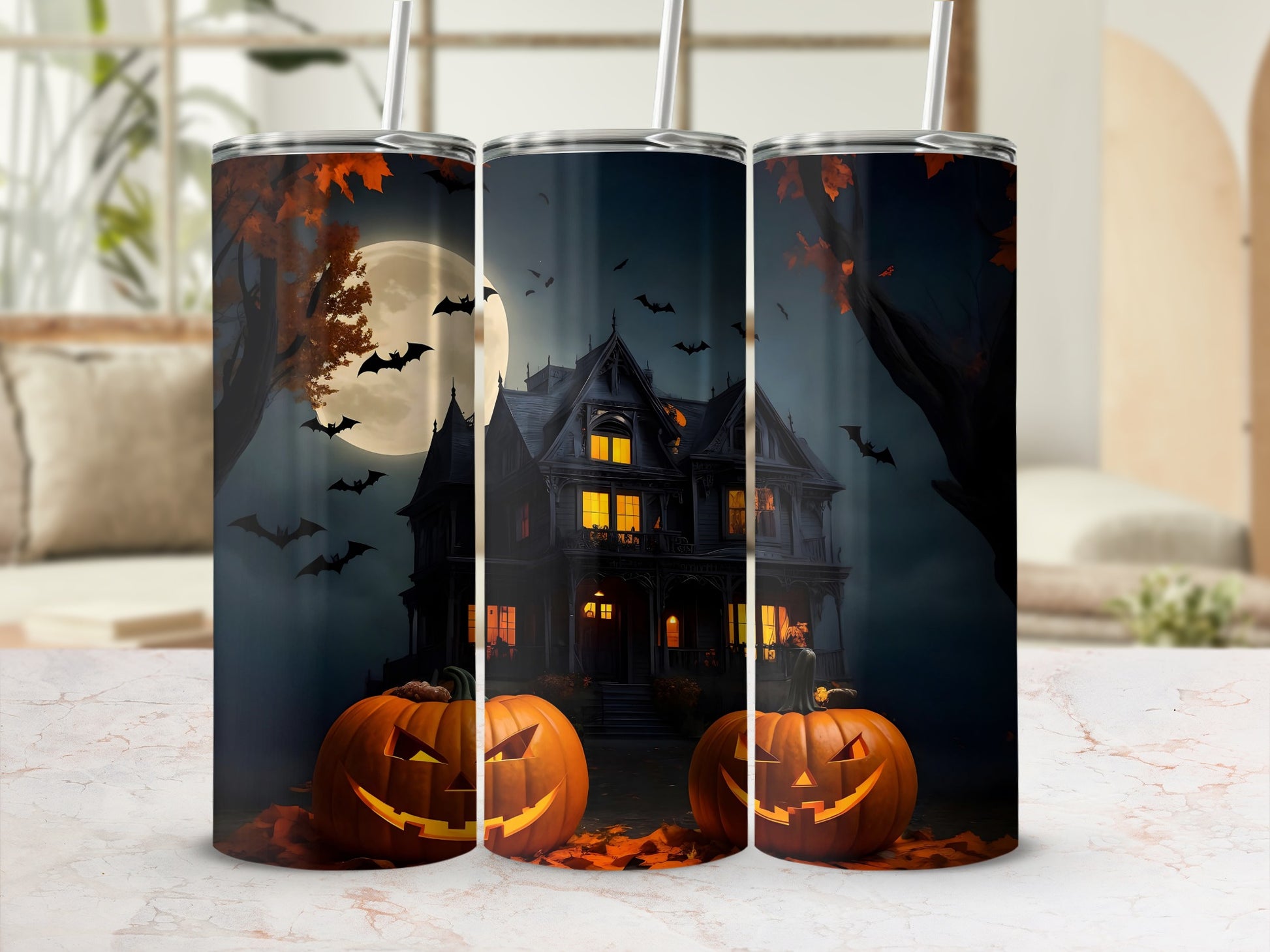 Three tumblers with Halloween design of a haunted house, pumpkins, bats, and moon.
