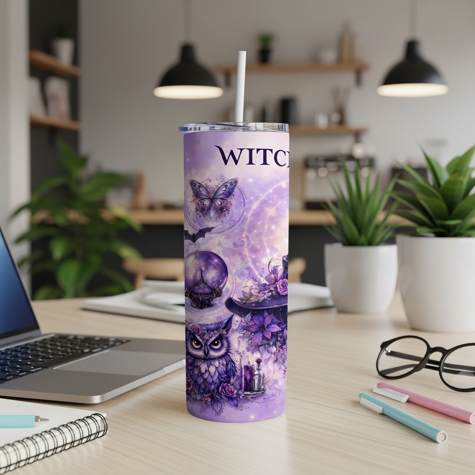 Purple tumbler with witchy owl, crystal ball, butterfly, and hat artwork.