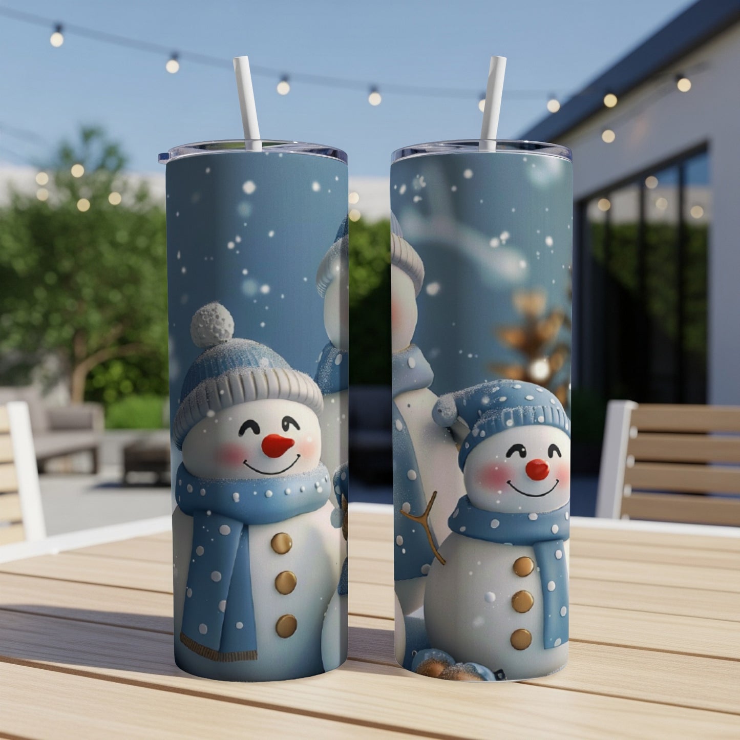 Two snowmen with blue hats and scarves, on a table outdoors.