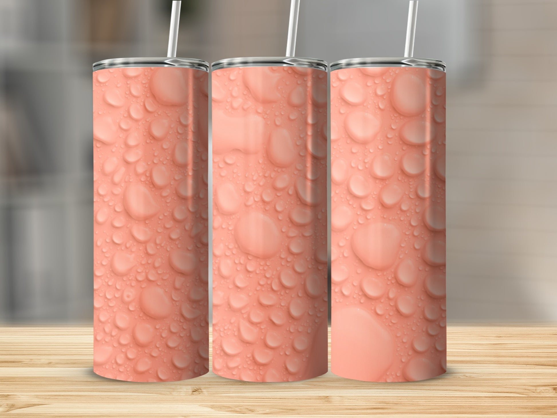Three seamless tumblers with a pattern of water droplets on a wooden surface.