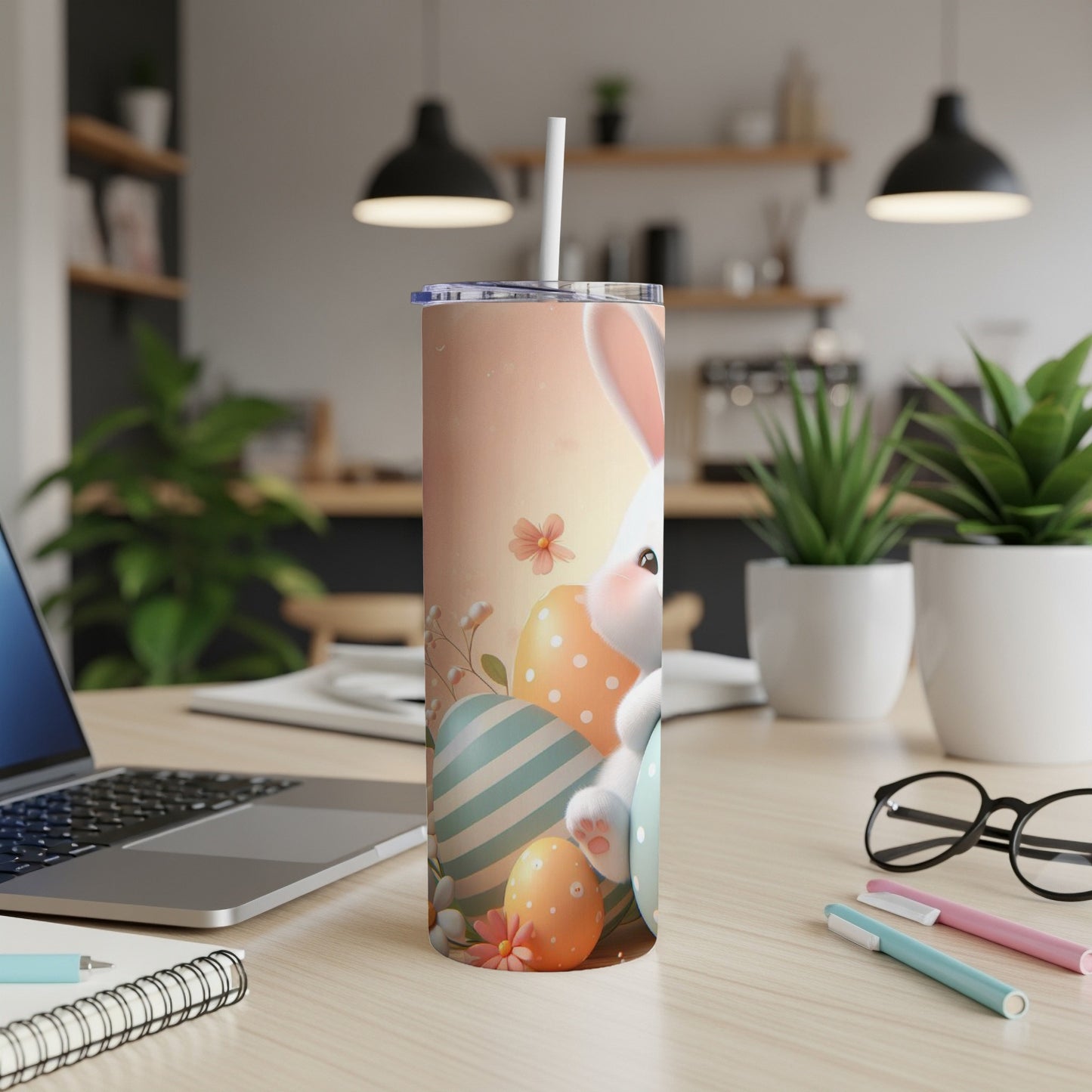 Easter bunny and painted eggs on a skinny tumbler with a straw.